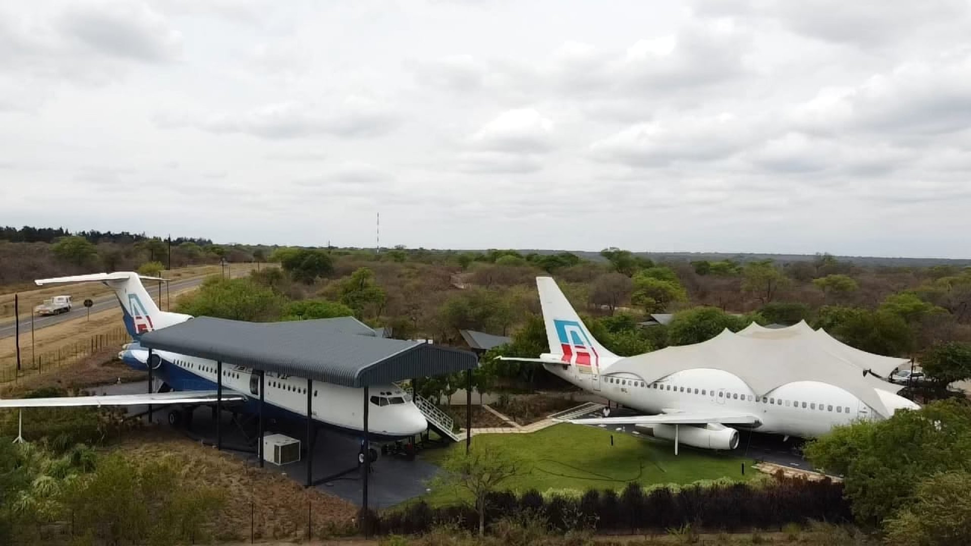 Aerial drone view of Aerotel showing both Boeing 737 and Boeing 727 aircraft surrounded by African bushveld